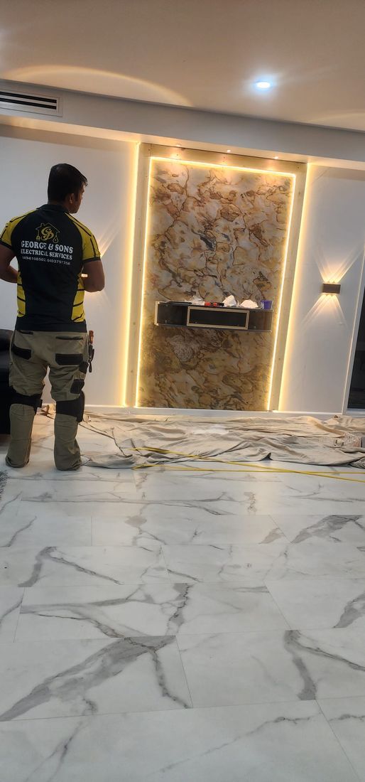 Ranjit George on site beside an LED feature wall he wired